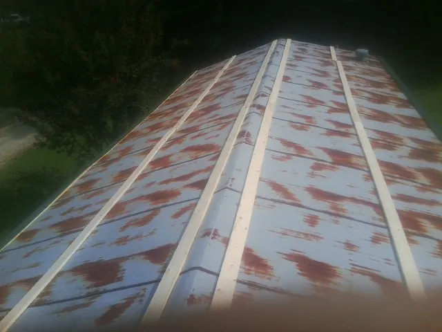 Rusted metal roof panels with new wood purlins before replacement — Storm Damage Roof Repair in Oglesby by Roofing Brothers