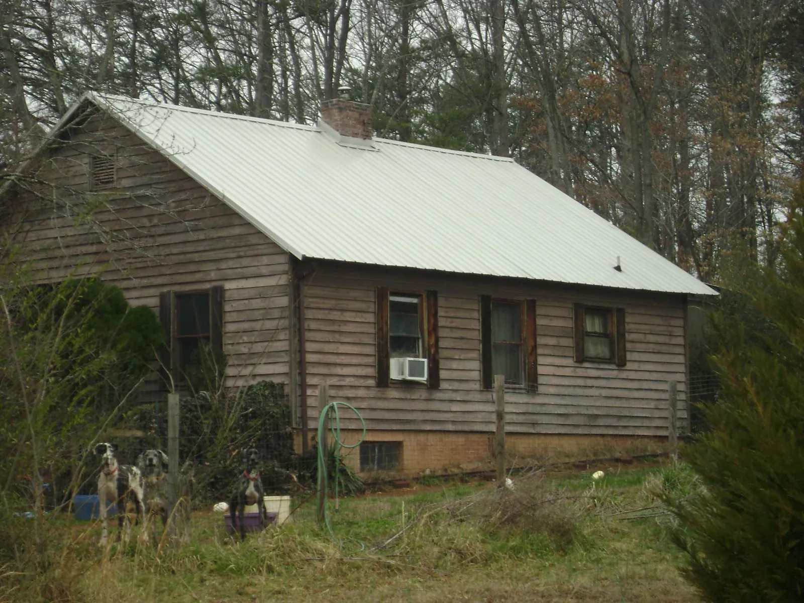 White metal roof on an old wood sided farmhouse, from a Metal Roof Installation job in Oglesby